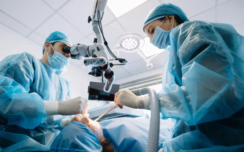 Surgeons performing a procedure in an operating theatre