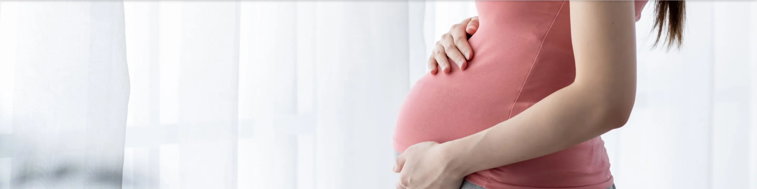 A pregnant woman holding her belly